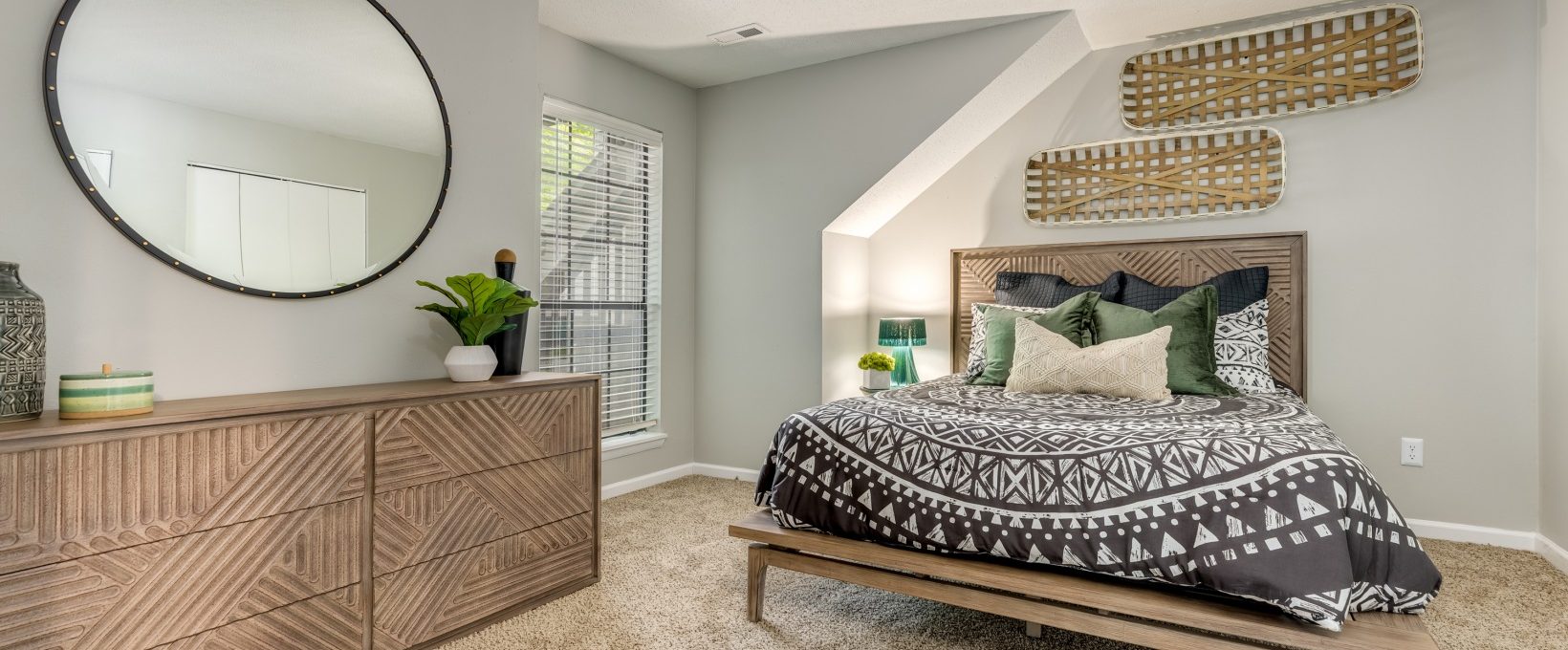a bedroom with a large bed and a mirror at The  Quinn on Ravenglass